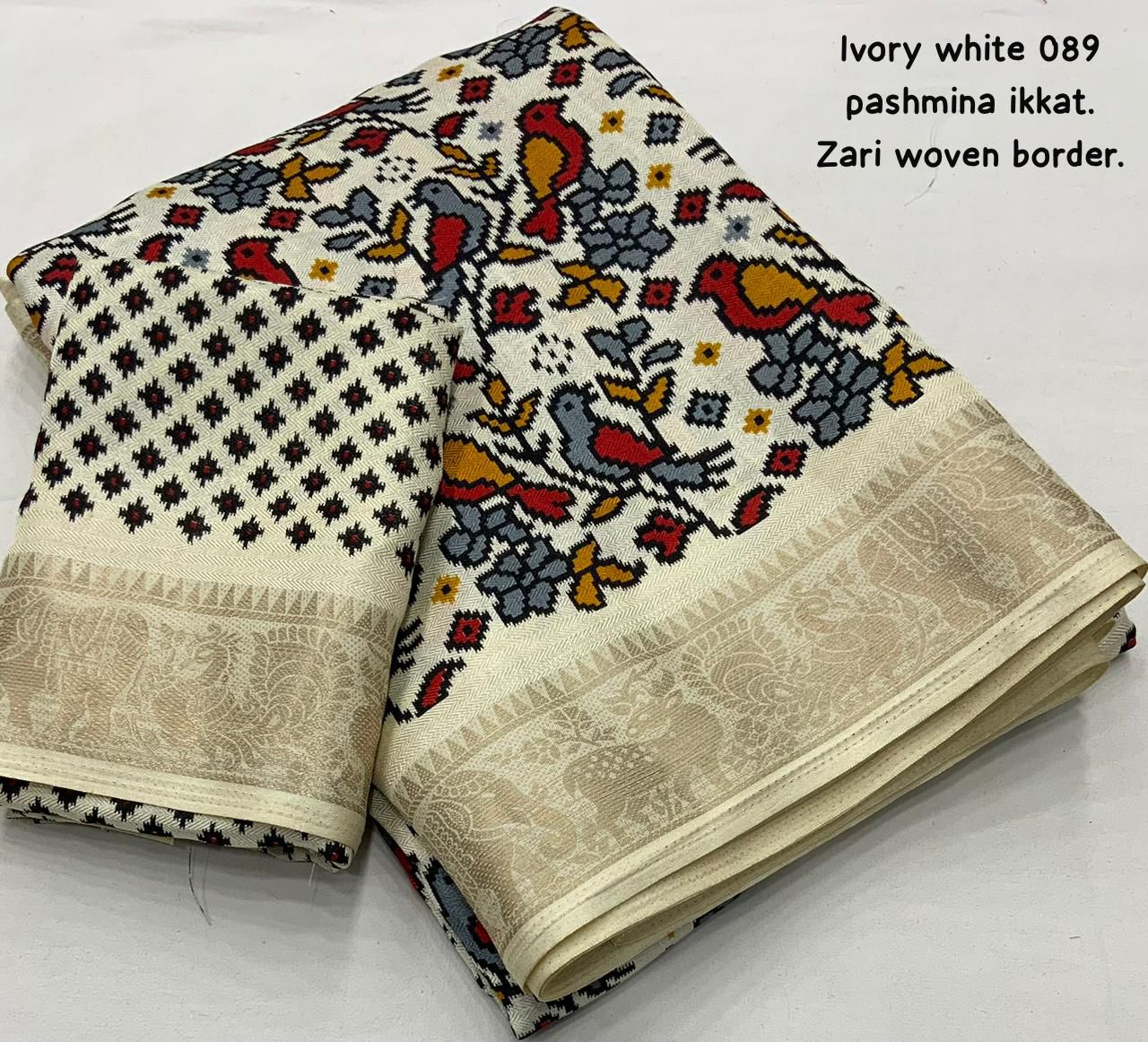 "Ivory White Pashmina Ikkat Style Printed Saree with Zari Border and Unstitched Blouse"