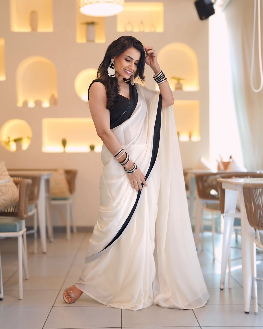 "DevSena White Saree: Elegant Japan Satin with Black Lace Border"